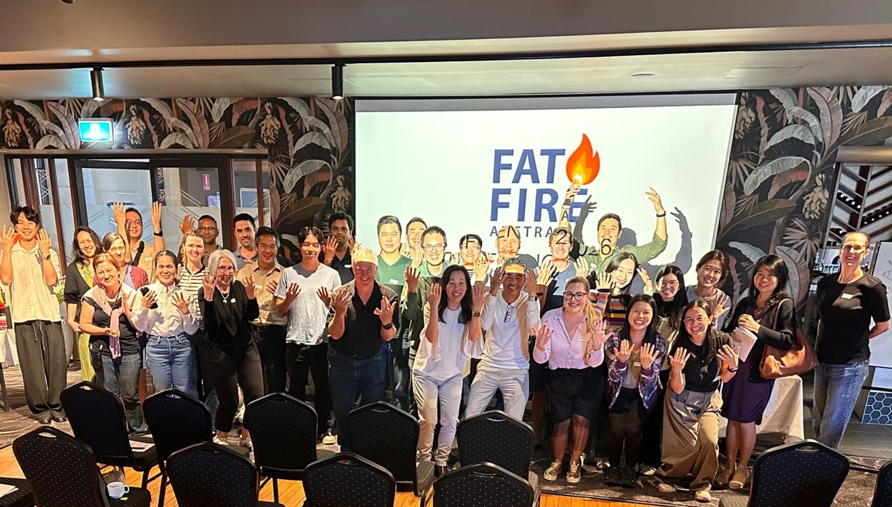 The Sydney room, attendees and panel together, waving in front of the FAT FIRE screen